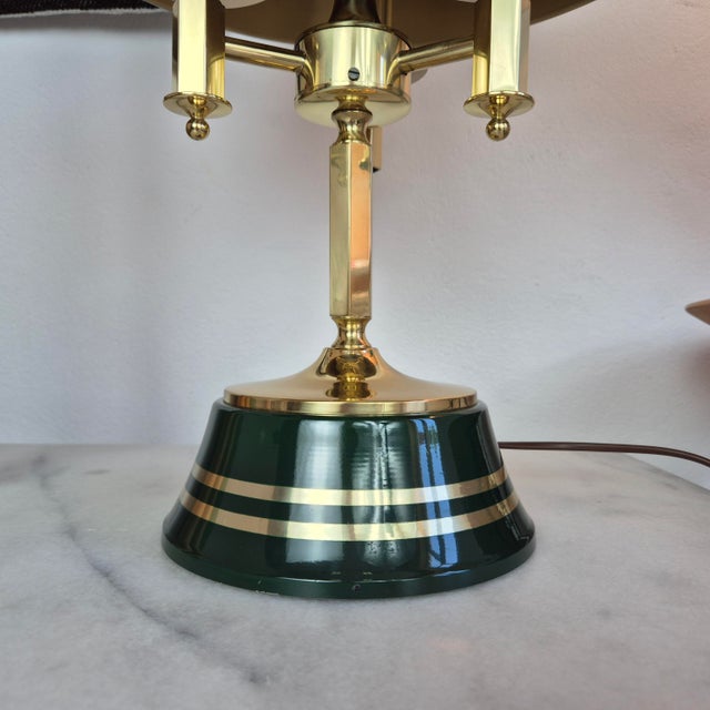 Elegant Swedish table lamp inspired by the classic banker’s lamp design, crafted from polished brass and enamelled metal....