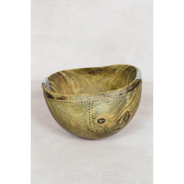 This hand-carved wooden bowl is made by the Turkana, a nomadic community in north-west Kenya prized for their woodcarving...
