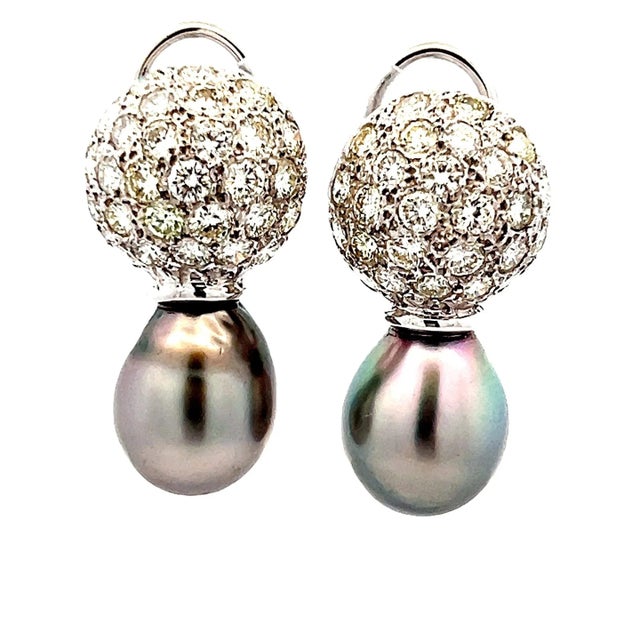 A refined blend of elegance and brilliance, these drop earrings are crafted in 18K white gold and feature lustrous South...