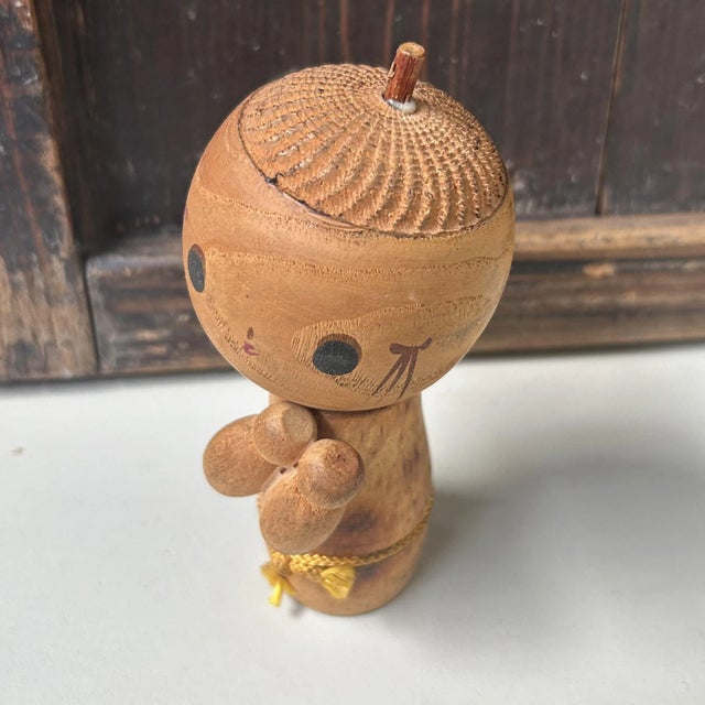 This playful and irresistibly kawaii sōsaku kokeshi is a charming example of the more expressive, creative style within...