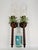 Striking pair of vintage metal palm tree wall candle sconces, each topped with a clear glass hurricane shade that...