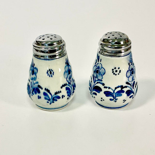 These are a pair of hand-painted Delft Salt & Pepper shakers from Ram, Holland. They are from the 1940s and feature one...