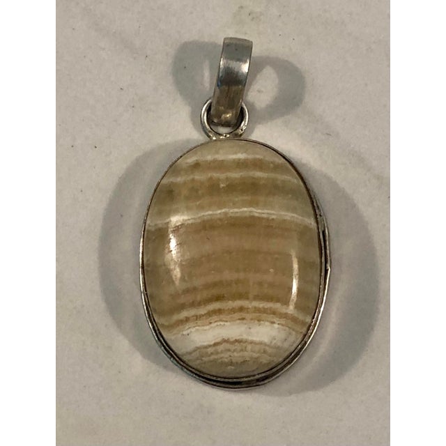 This fabulous Vintage Tan / Cream Oval Striped Agate Pendant is a standout with its elegant striped tan/cream cabochon...