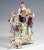 Meissen porcelain group from the time of origin: four children in festive, rural rococo clothing on a three-part rocaille...