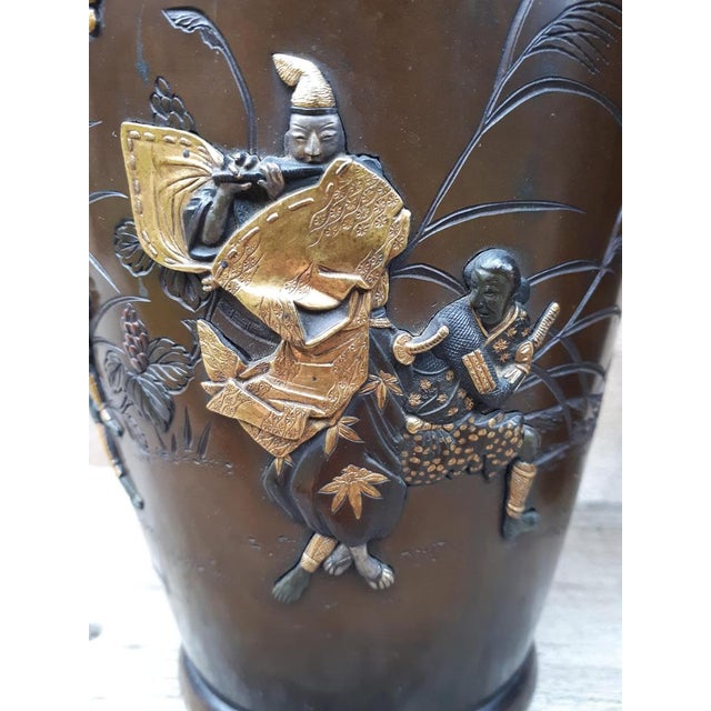 Pair of bronze vases with finely carved decorations inlaid with characters and birds moving in a pine forest. The inlays...