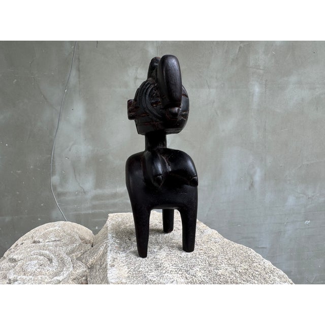 This striking vintage hand-carved wooden sculpture depicts a stylized female fertility figure inspired by the artistic...