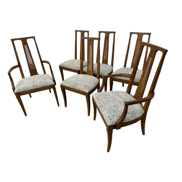 Elevate your dining space with this striking set of six Mid-Century Modern cane back dining chairs. Crafted with sleek...