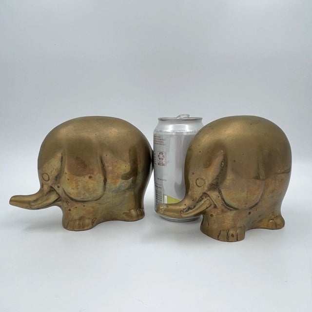 A pair of mid-century good fortune elephants are heavy enough to be utilized as bookends or doorstops; each adorable...