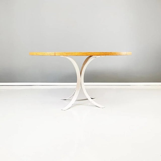 Italian modern round dining table in white metal and solid wood, 1970s. Dining table with round thick top of large...