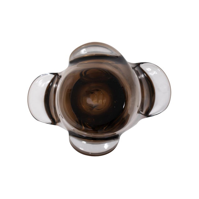 Featuring a sleek design and warm amber tones, this piece stands out with its fluid, sculpted shape, making it a...