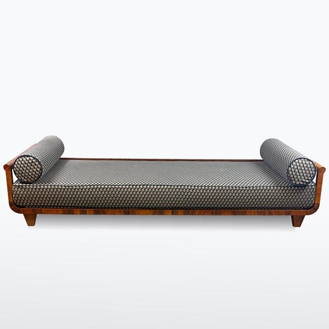 1930s Art Deco daybed with a walnut frame restored using traditional shellac polish. Newly upholstered with geometric...