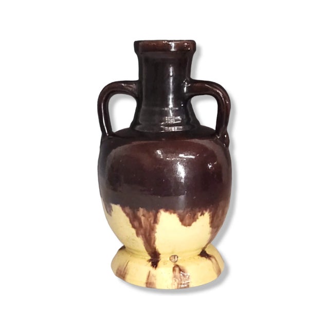 This is a lovely double-handle vase/urn. The vase features a handmade ceramic with drip glaze lava design. This vase will...