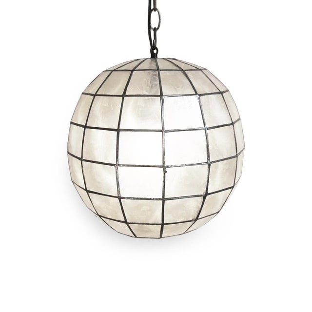 Stunning contemporary globe lantern made from delicate Capiz shell square pattern bonded together with pewter finish...