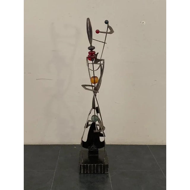 Beautiful wrought iron sculpture with colored resin balls. The work identifies jugglers in acrobatics. Unknown artist