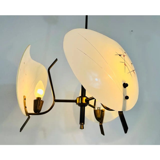 A Sputnik chandelier made in Italy in the 1950s. It is fascinating with its three brass arms, each of it with an special...