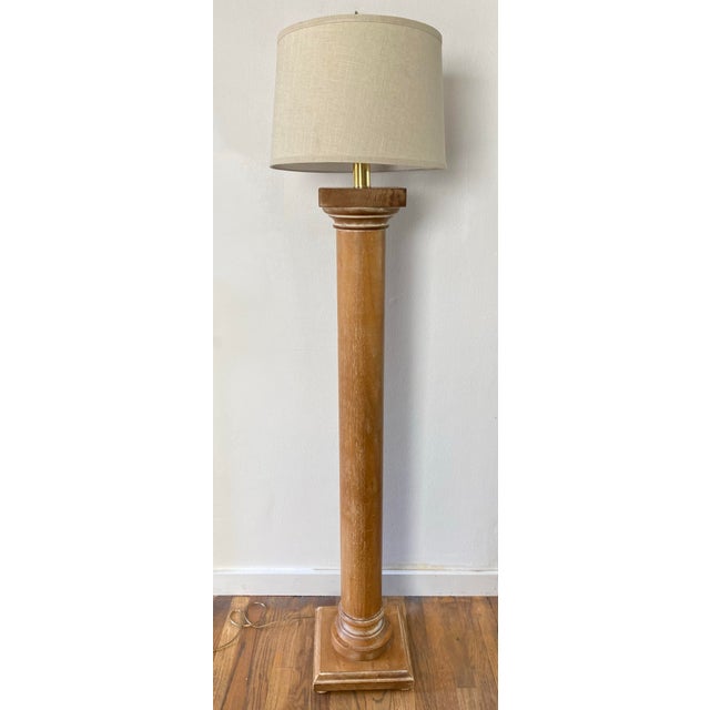 Tall, architectural floor lamp made in Italy, featuring a turned wood column in a warm, whitewashed light oak finish,...