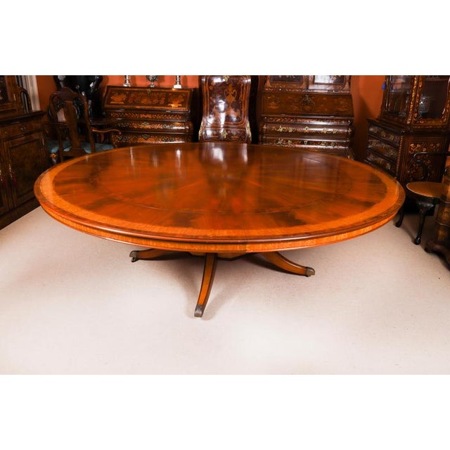 This is a superb vintage regency revival flame mahogany and satin wood banding dining room suite purchased at great...