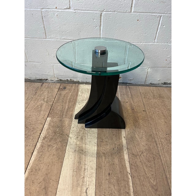 A striking Postmodern sculptural side table dating from the late 1980s to early 1990s, featuring a dramatic architectural...