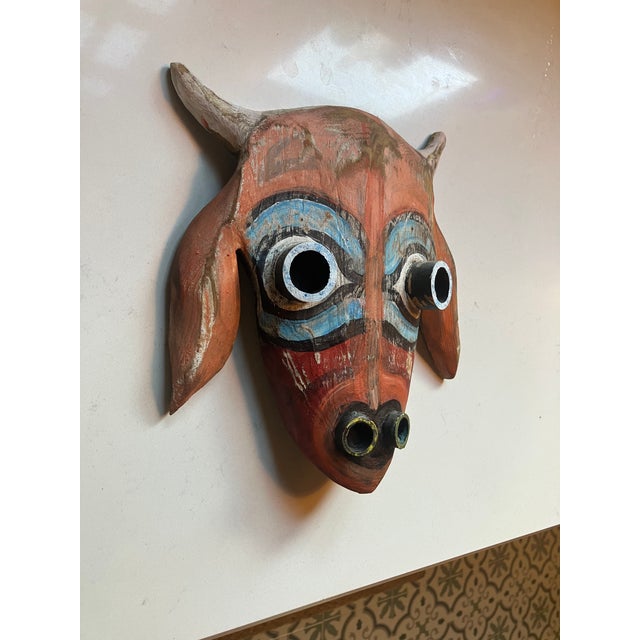 This whimsical mask depicts one of the small population of goats on the island. Hand carved from heart pine and bamboo...