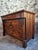 This French commode dates from the early 19th century (circa 1800–1830) and is crafted from solid walnut with walnut...