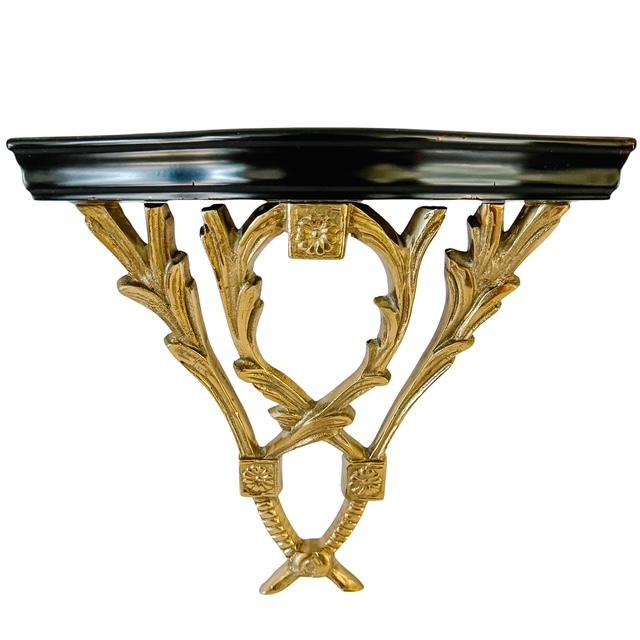 A striking pair of Neoclassical style wall console brackets featuring an elegant contrast of solid cast brass foliage and...