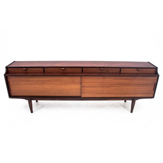 Teak sideboard, manufactured in Denmark in the 1960s. The furniture has four external drawers. Behind a pair of sliding...