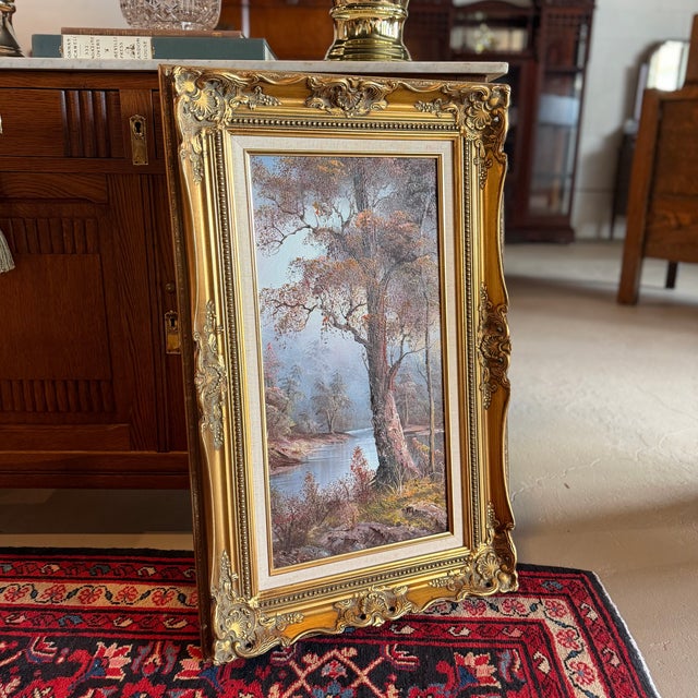 Beautifully framed vintage oil on canvas painting featuring a placid autumnal lake scene with lovely color and rich...