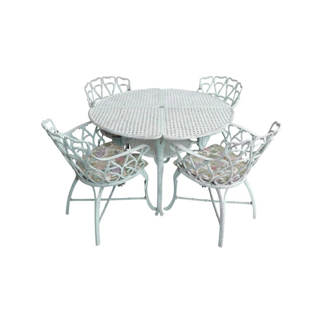 A verdigris patio dining table and four matching chairs circa 1970, made of cast aluminum. The table is constructed with...