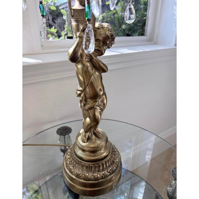 Dramatic oversized vintage Hollywood Regency table lamp featuring a beautifully sculpted cherub figure surrounded by...