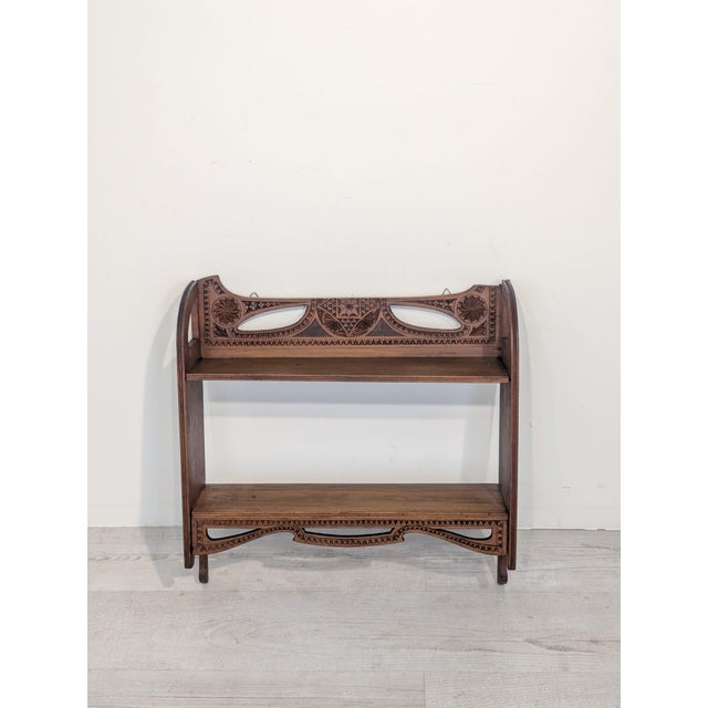 Antique-Style Carved Wall Shelf Stylish, hand-carved wall shelf in an antique style. Crafted from wood, it features...
