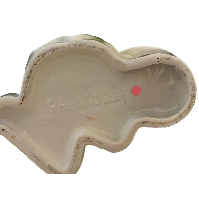 Wonderful little planter made by Royal Copley depicting a boy setting next to a large pot. Dimensions: 6.5"H x 6.5"W x 4.5"D