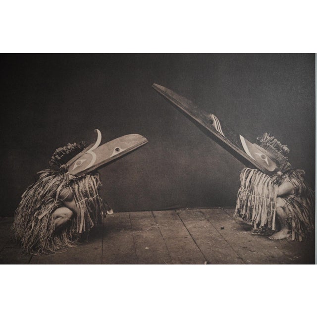 This is a vintage reproduction print of Edward S. Curtis’s photograph Kôtsuis and Hôhhuq – Nakoaktok, depicting ceremonial...