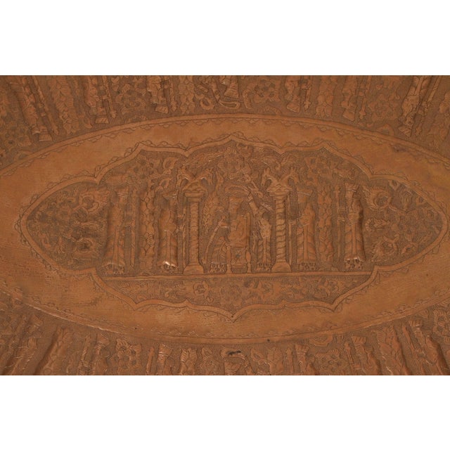 An impressive and unusually large Persian hand-hammered copper tray, richly decorated with repoussé and chased imagery...