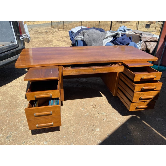The Alma Co Vintage Mid Century Modern Fan Walnut Executive Desk is a stunning piece of antique furniture from the 1960s....