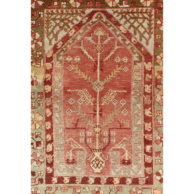 Antique Oushak Rug From Turkey With Directional Tribal Motifs in Soft Rose Red & Green For Sale - Image 4 of 7