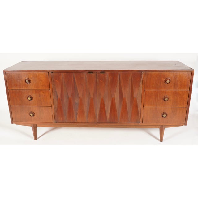 The "Harlequin" line was designed by Merton Gershun for American of Martinsville. This piece features nine drawers . This...