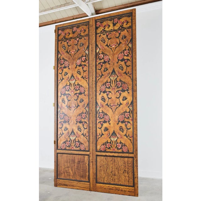 Extraordinary pair of massive art nouveau leather inset panel screens featuring flora and fauna embossed and painted...