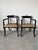Elegant pair of John Gee style Hollywood Regency armchairs featuring dramatic ebonized wood frames, graceful saber legs,...