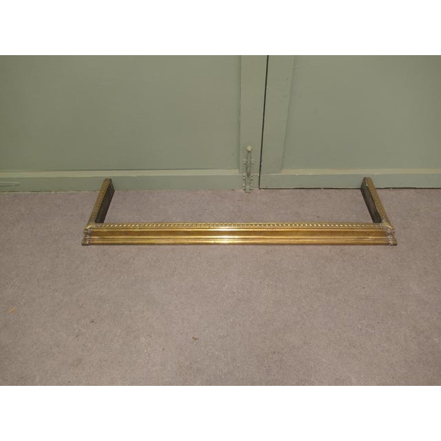 19th Century Brass Fender This is an elegant Brass fender with a stepped edge and hand beaten decoration, the fender is in...