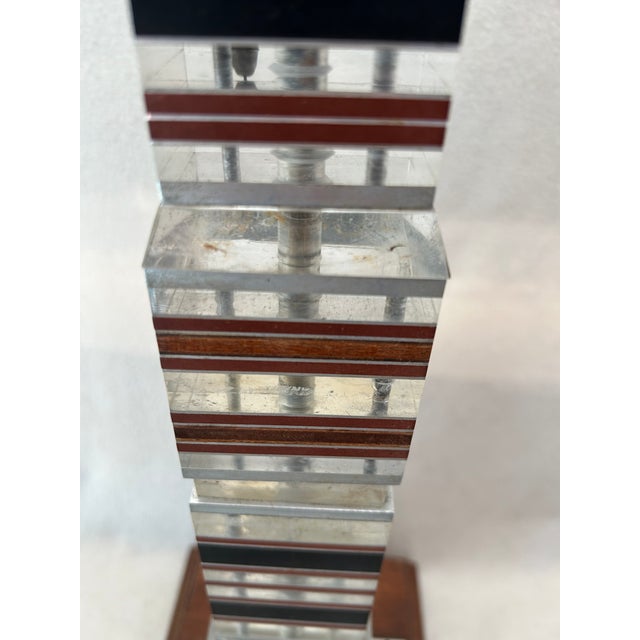 A striking Mid-Century Modern Stacked Lucite, Acrylic, and Teak “Skyscraper” Table Lamp, featuring a bold vertical...