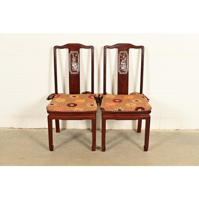 An outstanding pair of antique Chinese side chairs or dining chairs China, Circa 1890s Gorgeous carved rosewood, with...