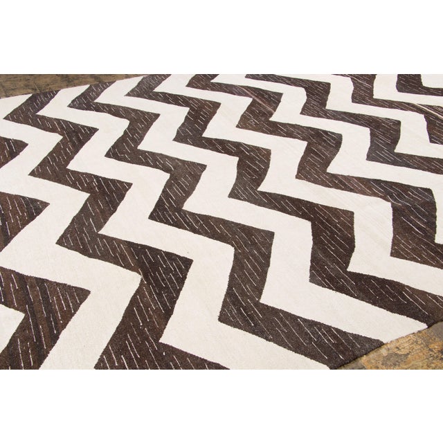 Handwoven from recycled vintage hemp and originating from Turkey circa 1950-1959, this 10x14 oversized vintage kilim joins...