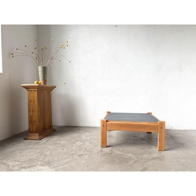 Modernist coffee table from the 1970s, crafted from solid pine with a square top, reminiscent of the mountain furniture of...