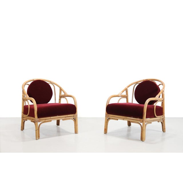 A beautiful set of two lounge chairs made of bamboo and reinforced with woven rattan. The chairs feature new cushions...