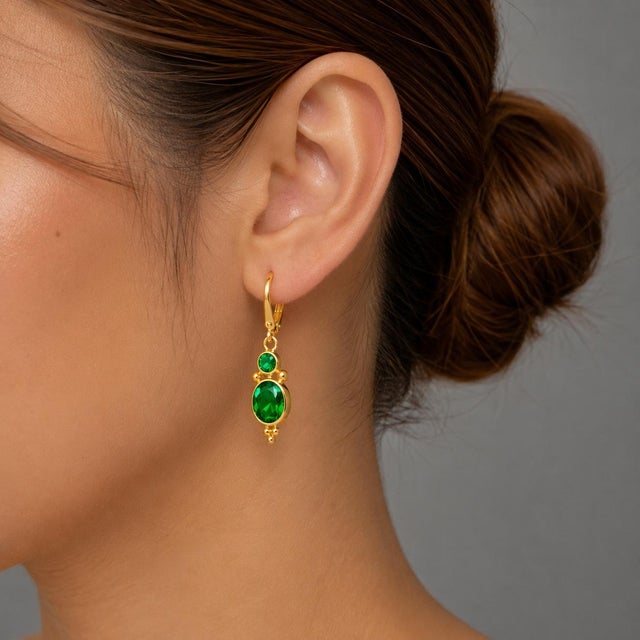 This elegant pair of 14K Yellow Gold Emerald Drop Designer Earrings showcases a timeless design, perfect for any occasion....