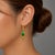 This elegant pair of 14K Yellow Gold Emerald Drop Designer Earrings showcases a timeless design, perfect for any occasion....