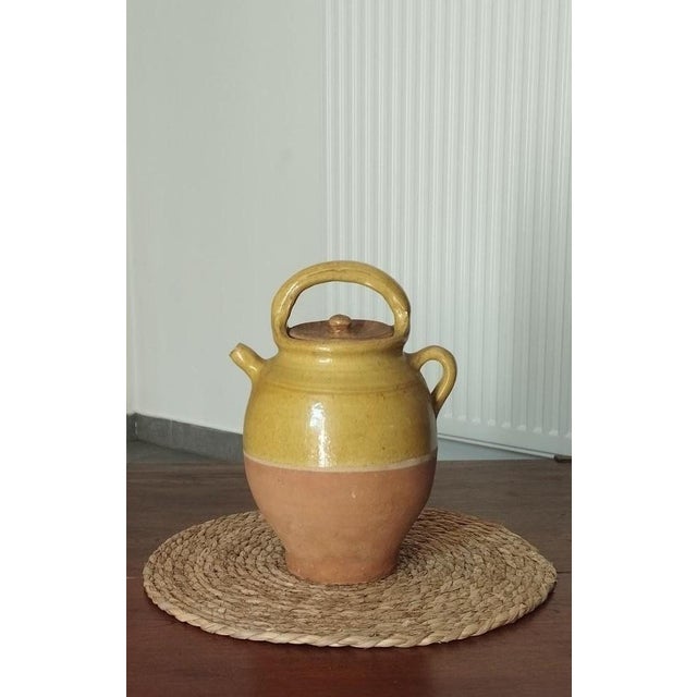 A charming two-tone terracotta water jug, an authentic and emblematic piece of folk art and utilitarian pottery from the...