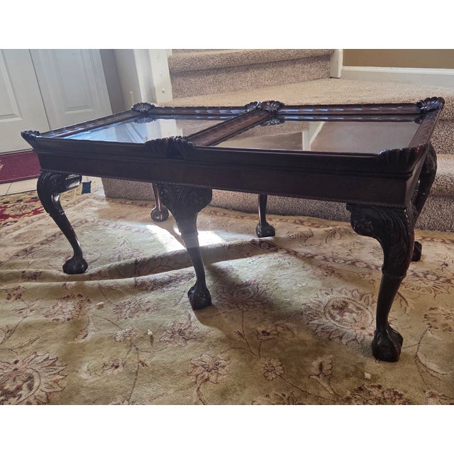 Chippendale coffee table with fitted framed glass panels that protect and reveal book matched panels below. The panels can...