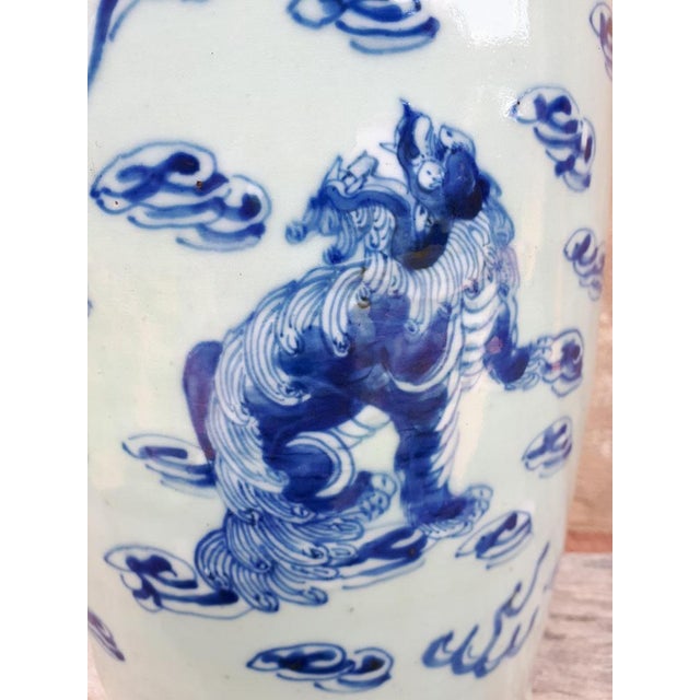 Large porcelain vase decorated in blue on a celadon background of shishis among the clouds. China, 19th century.