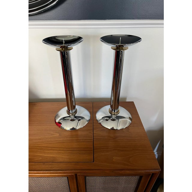 A rare pair of iconic chrome and brass candlestick holders / candelabras by influential, important & renowned 20th Century...